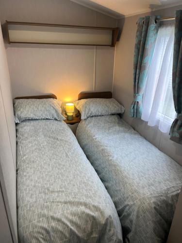 two beds sitting next to each other in a bedroom at BlackJak Retreat in Grange Over Sands