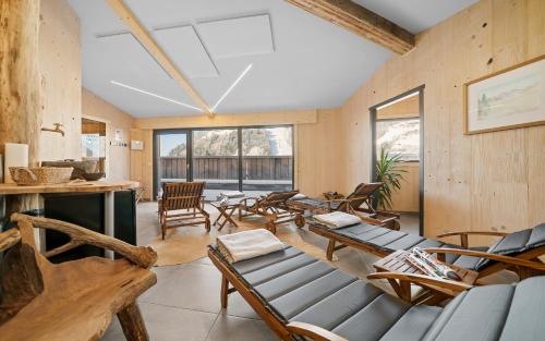 un soggiorno con mobili in legno e finestre di Aparthotel Zell am See (Contactless Check-In) a Zell am See