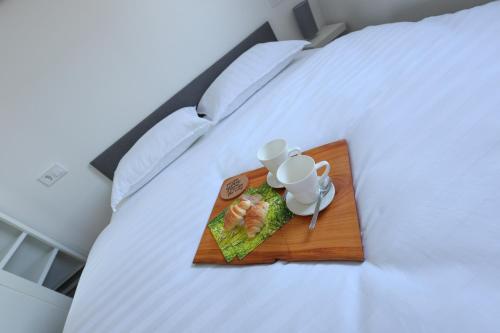 um prato de comida num tabuleiro numa cama em White Mountain Apartment em Banovci