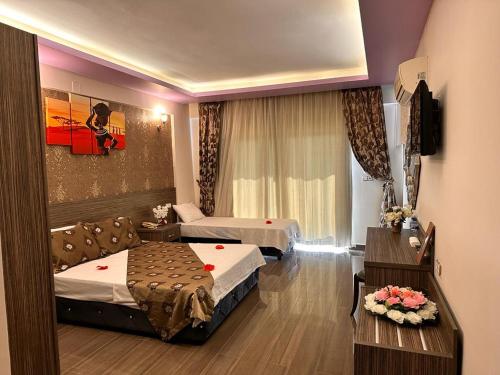 A bed or beds in a room at Truva Life Hotel