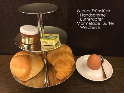 a plate of bread and eggs on a table at Elegance Apartment in Vienna