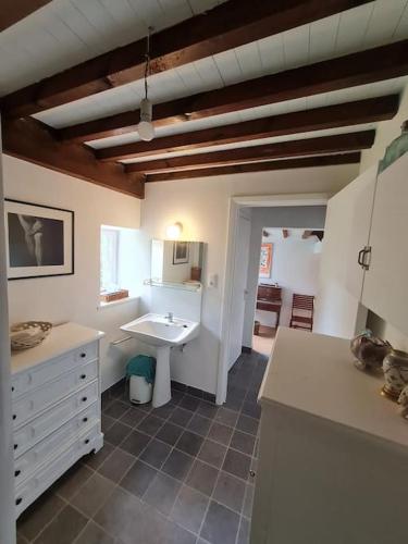 a kitchen with a sink and a counter top at La maison d'à côté in Tellin
