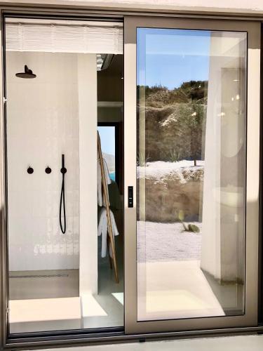 a window with a view of the beach through it at Mr. Bliss in Avlemonas
