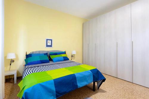 ein Schlafzimmer mit einem farbenfrohen Bett in einem Zimmer in der Unterkunft Casa tra gli ulivi vicino al mare in Seravezza