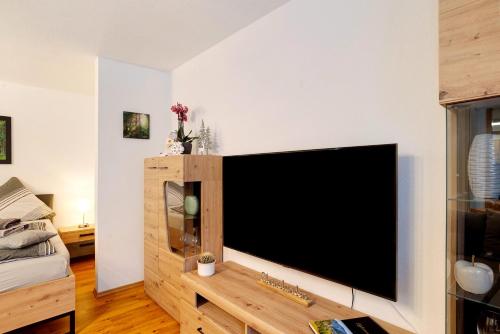 a living room with a large flat screen tv at Schwarzwaldnestle in Bad Wildbad