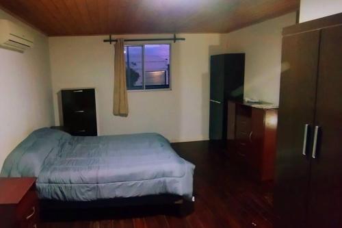 a bedroom with a bed and a window at María Chusena alojamiento 3 in Fray Bentos