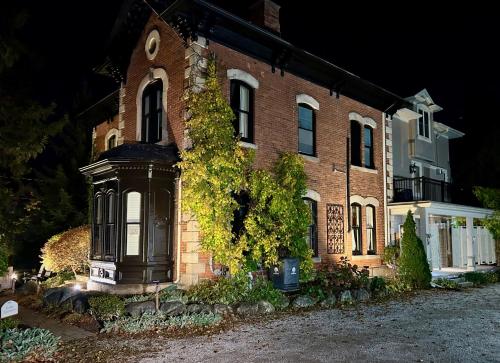 an old brick building with a cross on the front at Norfolk Guest House Inn in Guelph
