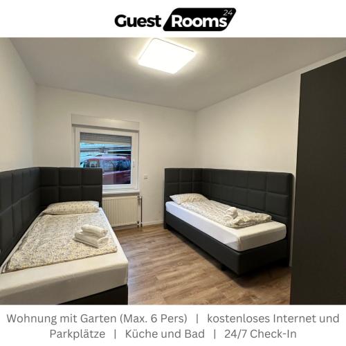 a room with two beds and a window and avertisement at Wohnung mit Garten EG - GuestRooms24 - Marl in Marl
