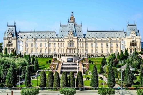 a large building with trees in front of it at Cazare Iasi Palas Apartment in Iaşi