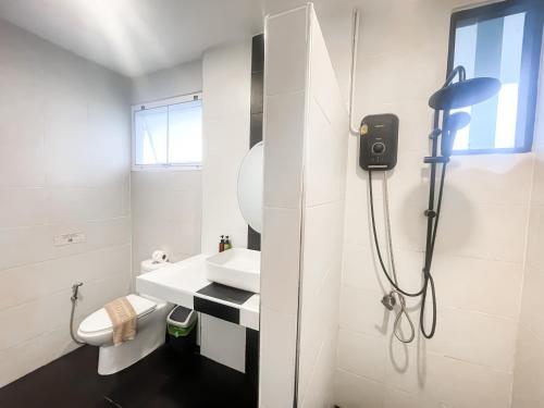 a white bathroom with a sink and a shower at Bounty Resort in Haad Son