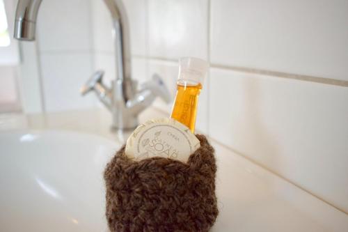 a bottle of soap sitting on a bathroom sink at Lütje in Greetsiel