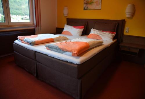 a bed with two pillows on it in a room at Frühstückspension Pachler in Gosau