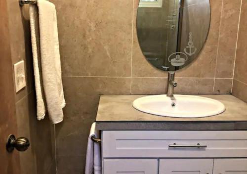 a bathroom with a sink and a mirror at Stunning Beach/Cliff side studio in paradise in Tamanique