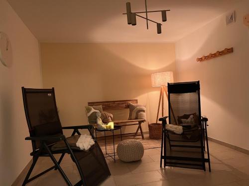 a living room with two chairs and a couch at Fewo Eickhorst in Menslage