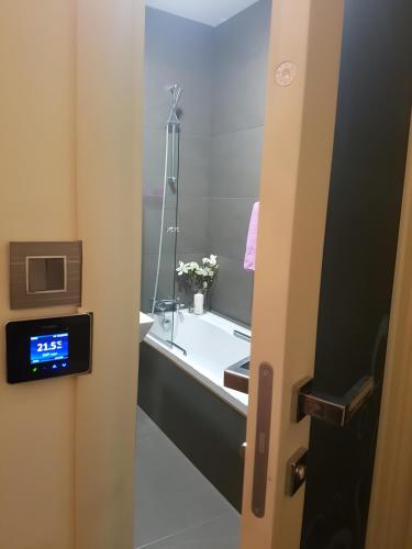a bathroom with a sink and a mirror at Top-notch apartment with sea view, bbq and Jacuzzi in St Julian's