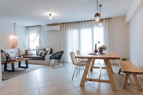 a living room with a table and a couch at Ona Boutique Apartments in Hanioti
