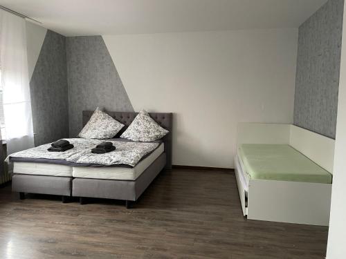 a small bedroom with a bed and a window at M&M Apartment Düsseldorf in Neuss