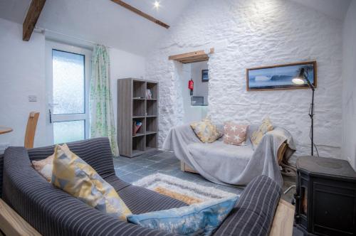 a living room with a couch and a table at The Anchor Light - 1 Bed - Freshwest Beach Retreat in Pembroke