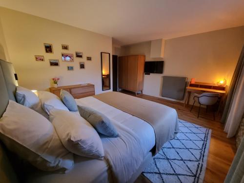 a bedroom with a large bed with pillows at Château de Villars in La Chapelle-Villars