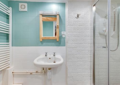 a bathroom with a sink and a shower at Pendeen Hayloft in Saint Stephen