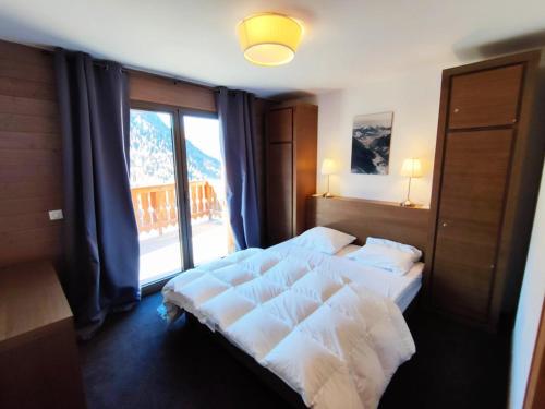 a bedroom with two beds and a large window at Appartement Isola 2000, 4 pièces, 8 personnes - FR-1-292-112 in Isola 2000