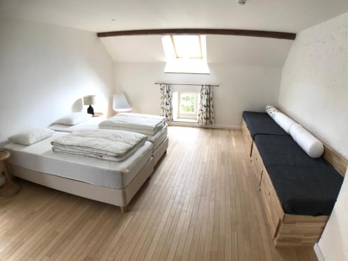 a large bedroom with two beds and a window at le Moulin de Braives in Braives