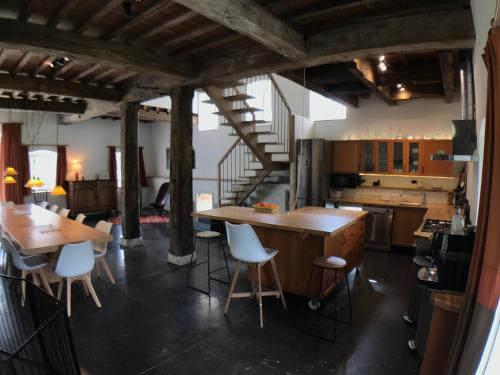 a kitchen with a large wooden table and chairs at le Moulin de Braives in Braives