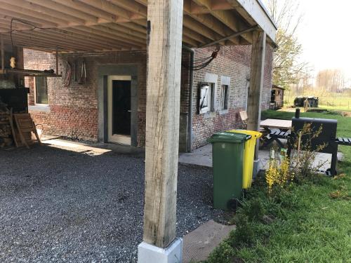 a pole with a trash can under a building at le Moulin de Braives in Braives