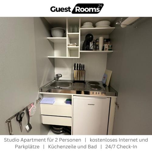 a small kitchen with a stove and a sink at Studio Apartment - GuestRooms24 - Marl in Marl