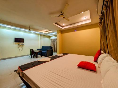 a bedroom with a large bed and a living room at HOTEL SUN CITY in Puri