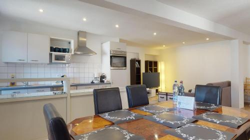a kitchen with a table and chairs in a kitchen at COLMARAPPART Grand'Rue in Colmar