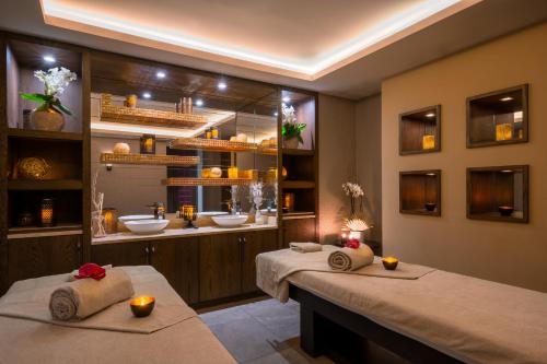 two beds in a bathroom with two sinks at Tiara Miramar Beach Hotel & Spa in Th&eacute;oule-sur-Mer