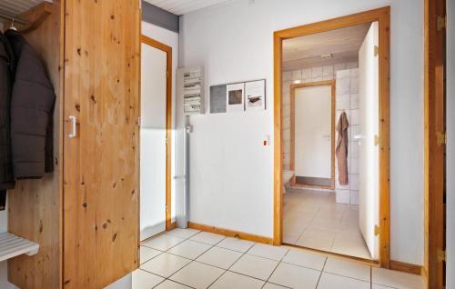 a room with a white refrigerator and a doorway at Gorgeous Home In Fars With Sauna in Farsø