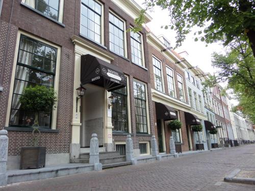 
a brick building with a clock on the side of the building at Hotel Royal Bridges in Delft
