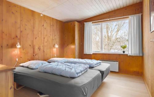een slaapkamer met 3 bedden in een kamer met een raam bij Gorgeous Home In Fars With Sauna in Farsø