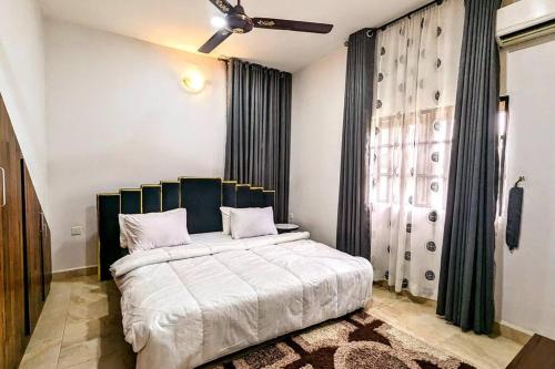 a bedroom with a large bed and a window at The Zen Haven in Uyo