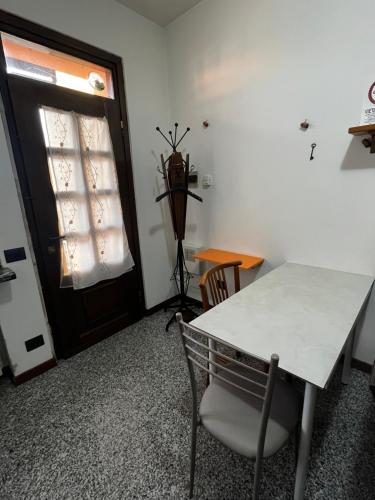 una mesa y una silla en una habitación con ventana en Camera con bagno Mirjana, en Cislago
