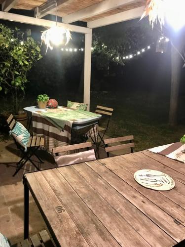 a table and chairs on a patio at night at Il Cantuccio in Cascina