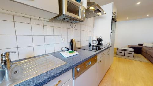 a kitchen with a sink and a counter top at COLMARAPPART Grand'Rue in Colmar