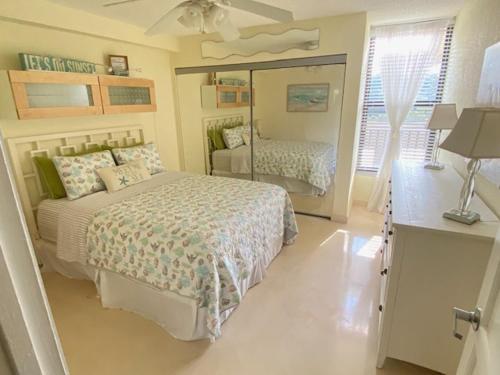 a bedroom with a bed and a large mirror at Moon Bay Condo, Paradise Found in Sunny Key Largo, Florida in Key Largo