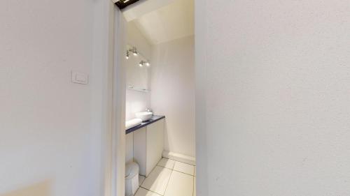 a white bathroom with a sink and a toilet at COLMARAPPART Grand'Rue in Colmar