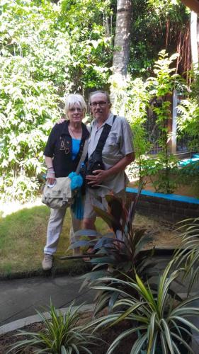 a man and a woman standing in a garden at Green Villa in Oluvil