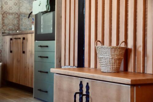 a kitchen with a counter with a basket on it at Cottage Dzudovic 2 Vikendica Džudović 2 in Kolašin