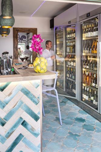a man standing in front of a refrigerator at Boutique Hotel Solaz in Porto Rafael