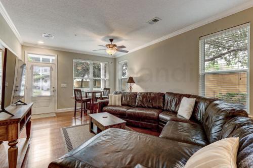 a living room with a leather couch and a table at 2142 Cape Sound in Fernandina Beach