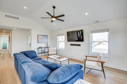 a blue couch in a living room with a ceiling fan at Spacious Wildwood Condo Walk to Beach! in Wildwood