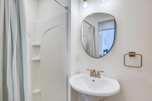 a white bathroom with a sink and a mirror at Spacious Wildwood Condo Walk to Beach! in Wildwood