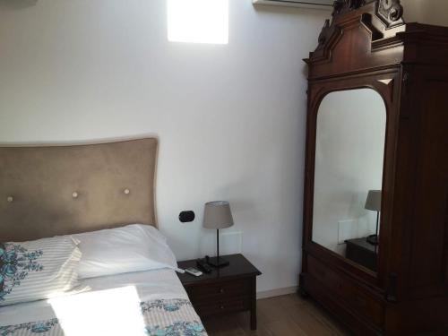a bedroom with a bed and a large mirror at La Villa Bianca Guest house in Cantù