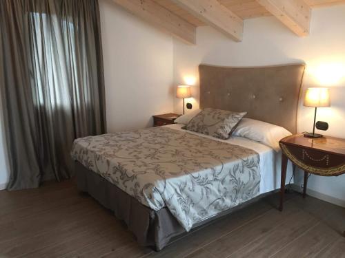 sypialnia z łóżkiem, 2 lampami i oknem w obiekcie La Villa Bianca Guest house w mieście Cantù