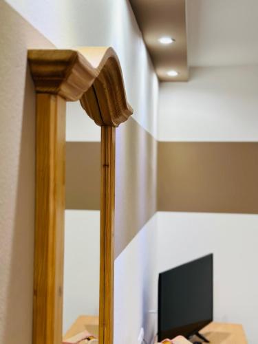a wooden pole with a television in a room at Öreg Prés Butikhotel in Mór